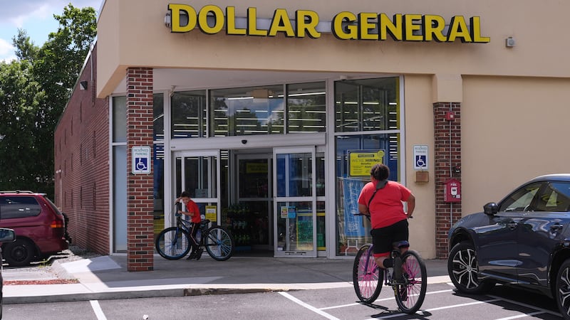 FILE - Children ride their bicycles to the Dollar General store, Aug. 21, 2025, in Nashua, N.H.