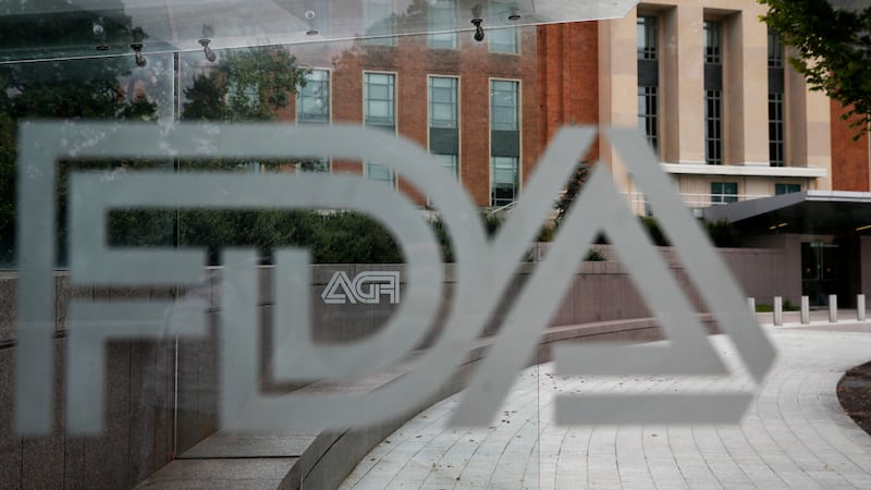 FILE - A U.S. Food and Drug Administration building is seen behind FDA logos at a bus stop on...